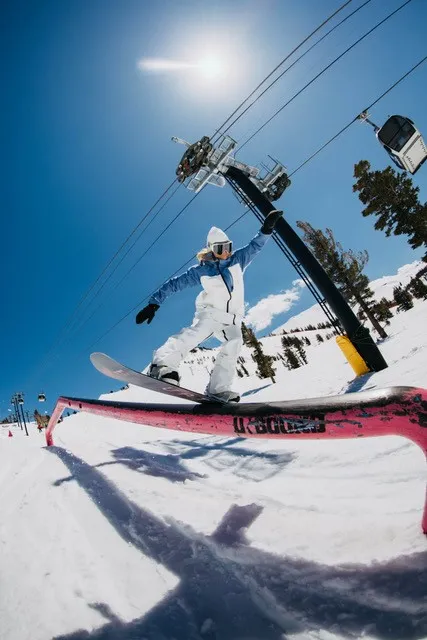 Snowboarder on a pink rail