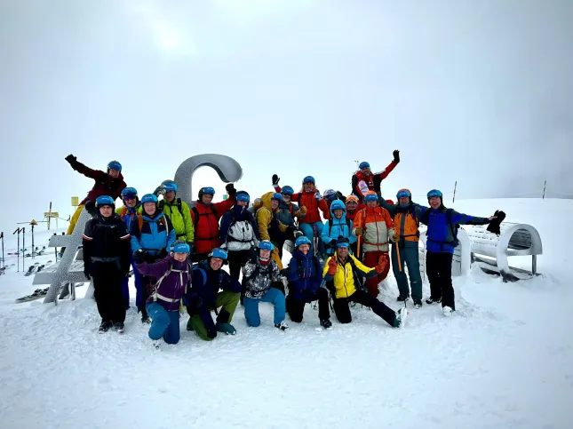 Ski Club GB Group photo with snow in the background