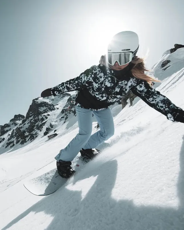 Snowboarder going down a snow slope